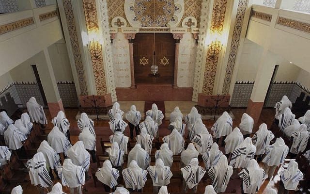 Congregants praying at the Kadoorie – Mekor Haim synagogue in Porto, Portugal