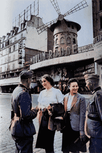 German soldiers talking with French women by the Moulin Rouge in June 1940