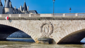 bridge with Napoleon logo in Paris seine river